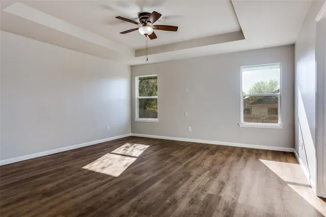 an empty room with windows and closet