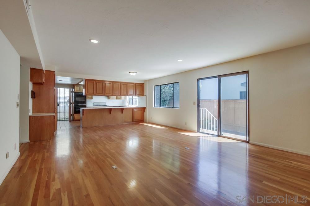 349 G Coronado, CA 92118 - Photo 9 of 18 a view of empty room with wooden floor and kitchen view