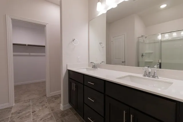 a bathroom with a shower and a glass door