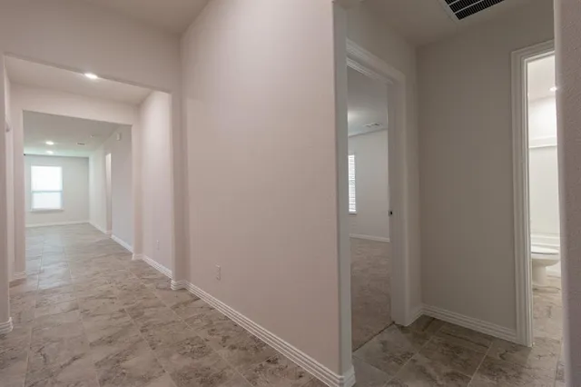 a view of a hallway with wooden floor and closet