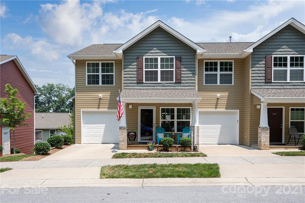198 Alpine Ridge Drive Asheville, NC 28803 - Photo 24 of 24 a front view of a house with a yard and garage