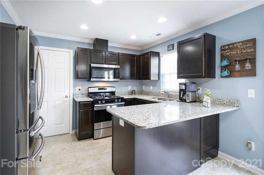 198 Alpine Ridge Drive Asheville, NC 28803 - Photo 7 of 24 a kitchen with a sink stove and refrigerator