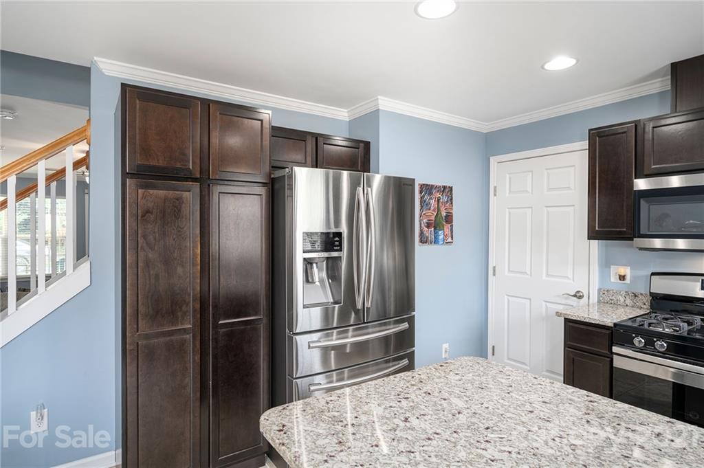 198 Alpine Ridge Drive Asheville, NC 28803 - Photo 8 of 24 a kitchen with stainless steel appliances granite countertop a refrigerator stove and microwave