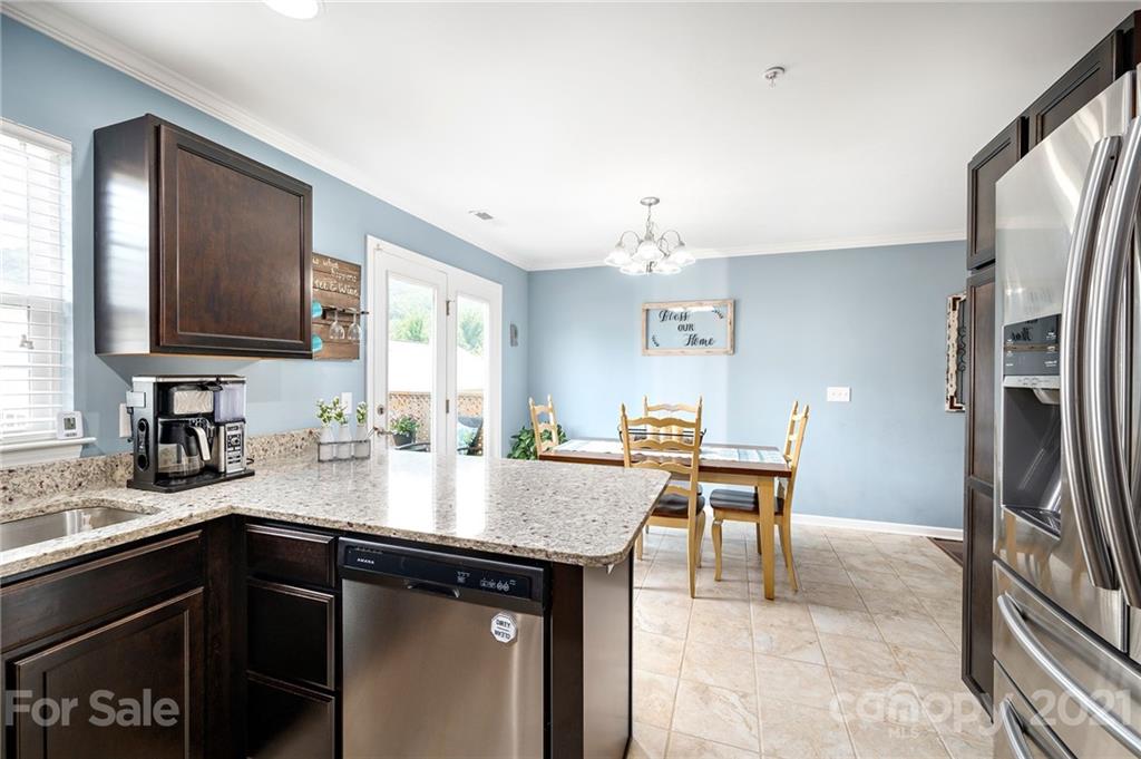 198 Alpine Ridge Drive Asheville, NC 28803 - Photo 10 of 24 a kitchen with a center island and stainless steel appliances