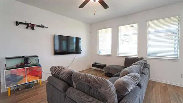 a living room with furniture and a flat screen tv