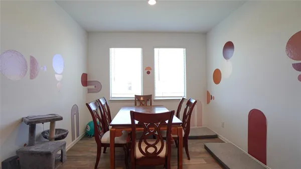 a dining room with furniture and window