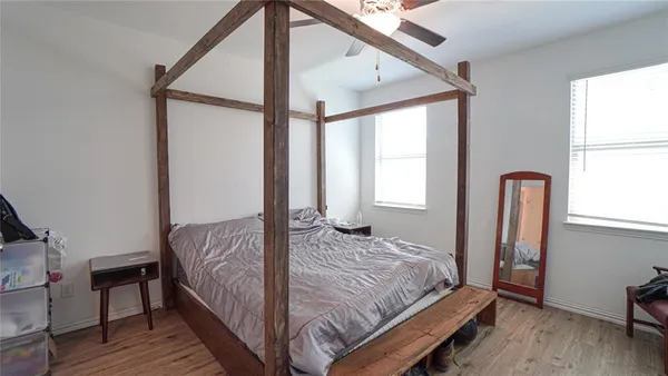 a bedroom with a bed and a window
