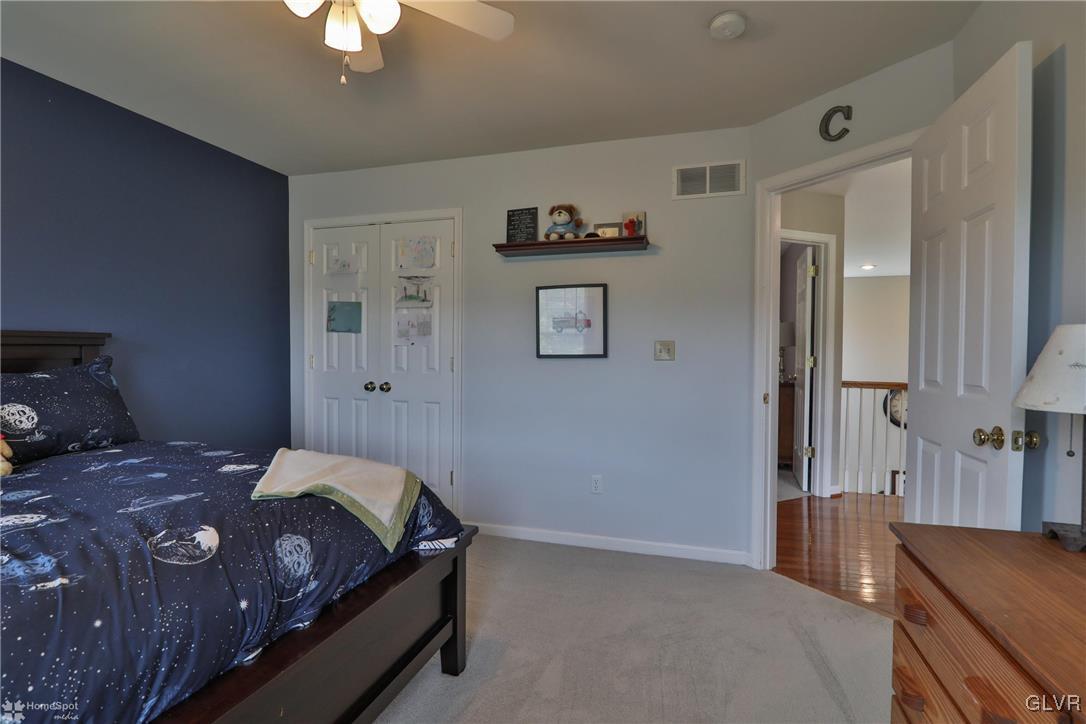 115 Kichline Road Hellertown, PA 18055 - Photo 23 of 45 a bedroom with a bed and a chandelier