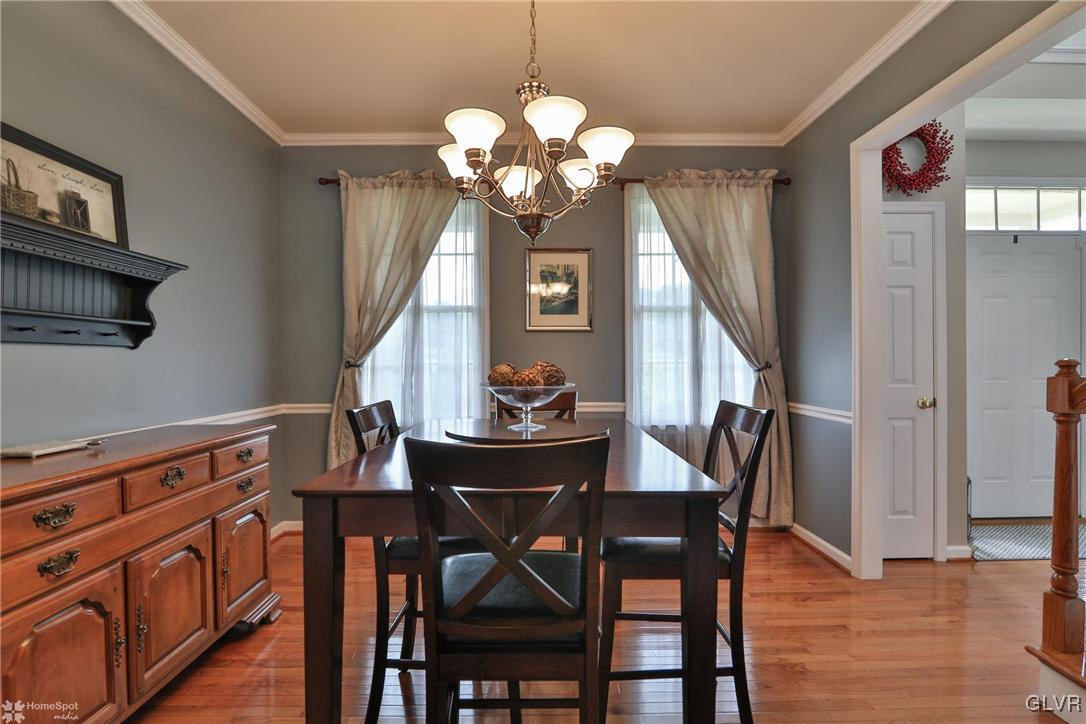115 Kichline Road Hellertown, PA 18055 - Photo 7 of 45 a dining room with wooden floor a chandelier a wooden table and chairs
