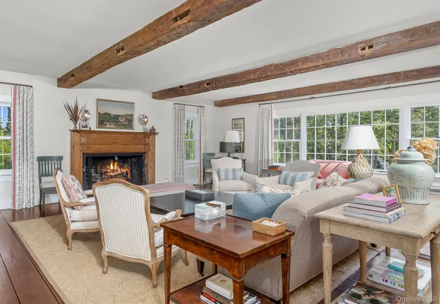 a living room with fireplace furniture and a large window