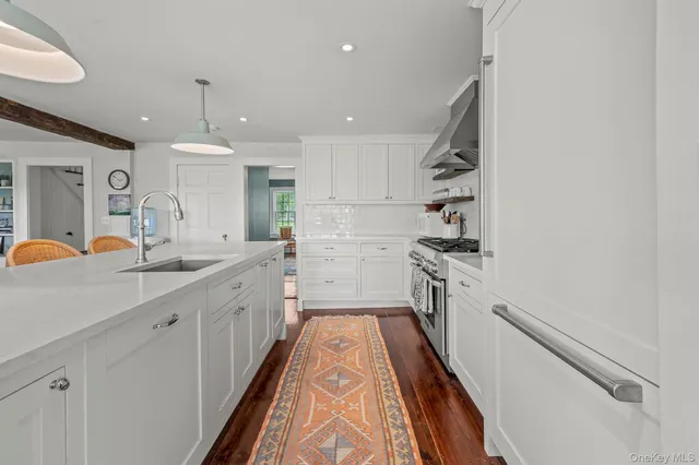 a kitchen with a sink and refrigerator