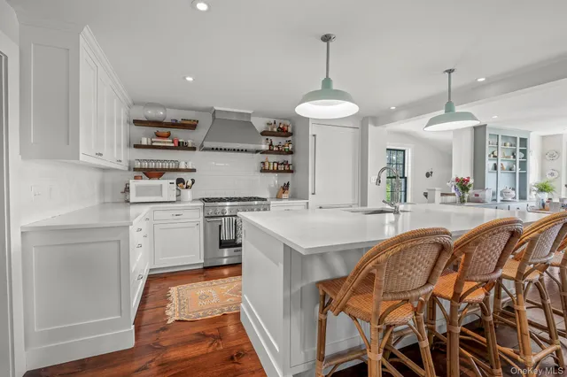 a kitchen with stainless steel appliances kitchen island granite countertop a sink and cabinets