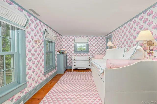 a bedroom with a bed and a lamp next to a window