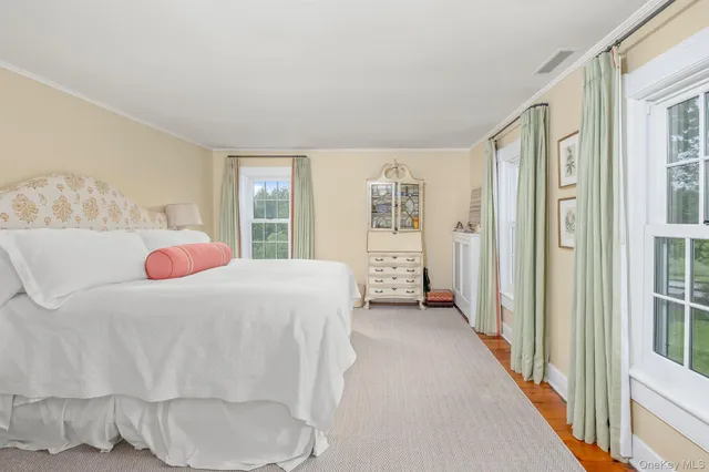 a bedroom with a bed and a large window