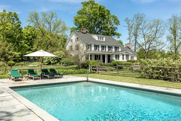 swimming pool view with a seating space and a garden view