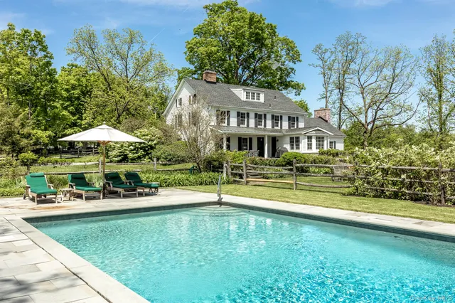 swimming pool view with a seating space and a garden view