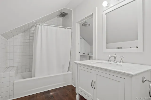 a bathroom with a sink a mirror and a shower