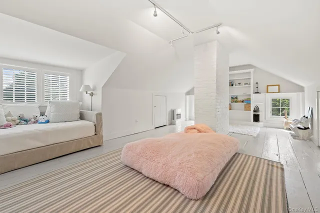 a spacious bedroom with a bed and a couch