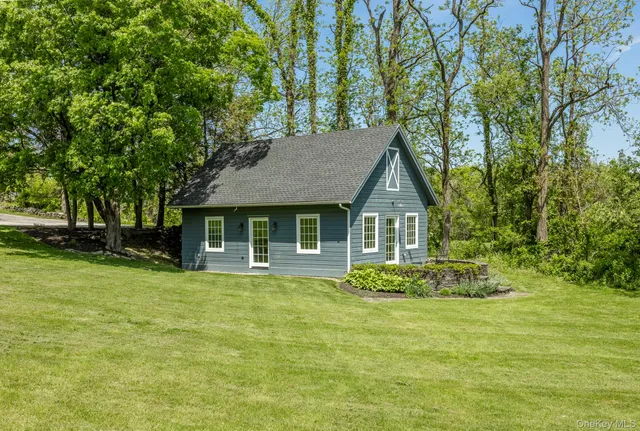 a front view of a house with a garden