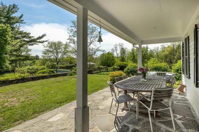 a view of a patio with a table chairs and a table