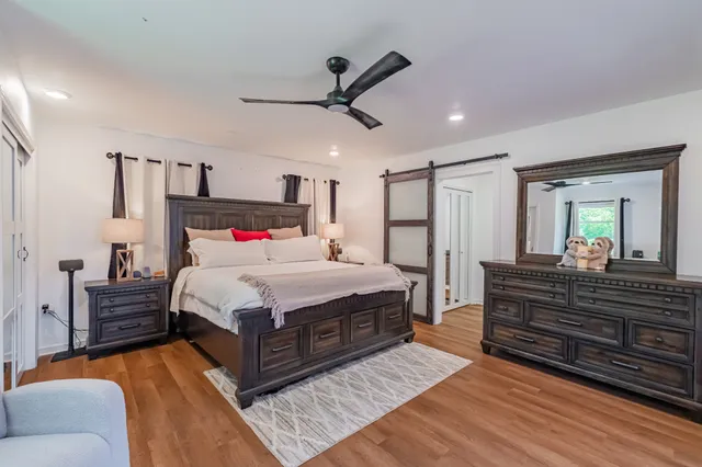 a bedroom with a bed and a mirror