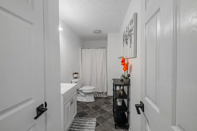 a bedroom with a large bed and a chandelier