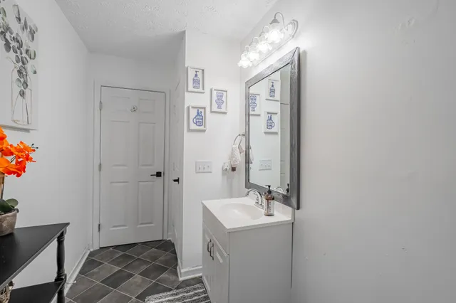 a bedroom with a bed and a mirror