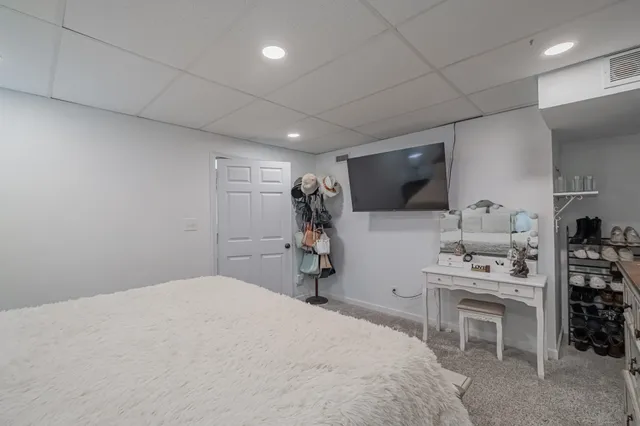 a large kitchen with wooden floors and stainless steel appliances