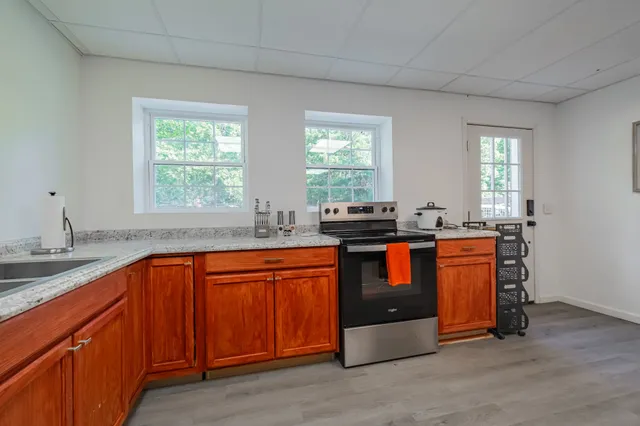 a view of a house with backyard sitting area and garden
