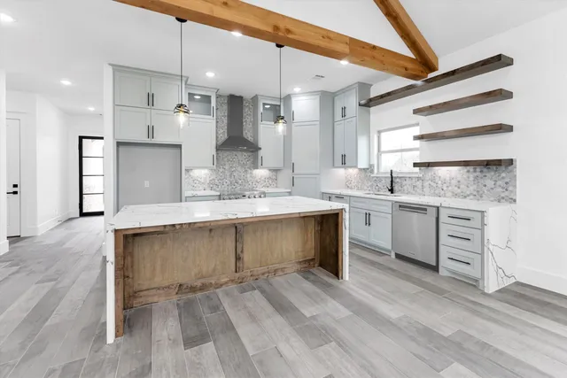 a kitchen with a sink stove and cabinets