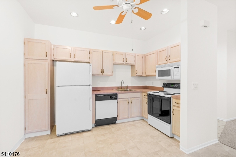 4 Richmond Road West Milford, NJ 07480 - Photo 6 of 25 a kitchen with stainless steel appliances granite countertop white cabinets a refrigerator a sink a stove a microwave and island