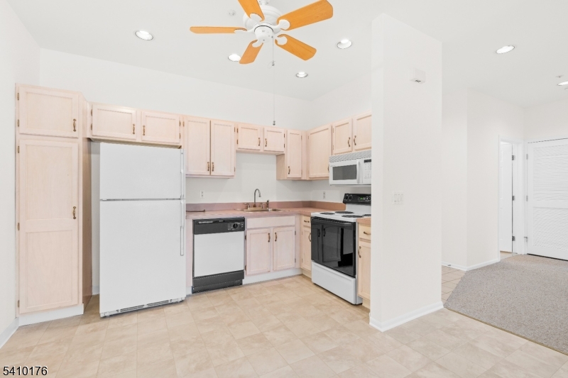 4 Richmond Road West Milford, NJ 07480 - Photo 7 of 25 a kitchen with a refrigerator a stove top oven and cabinets