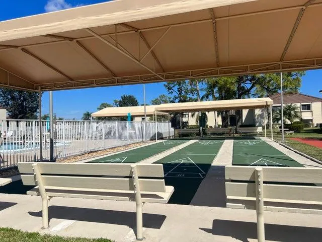 a view of a patio with table and chairs under an umbrella