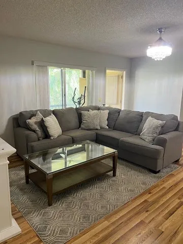 a living room with furniture and a large window