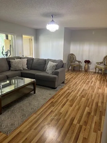 a living room with furniture and a chandelier