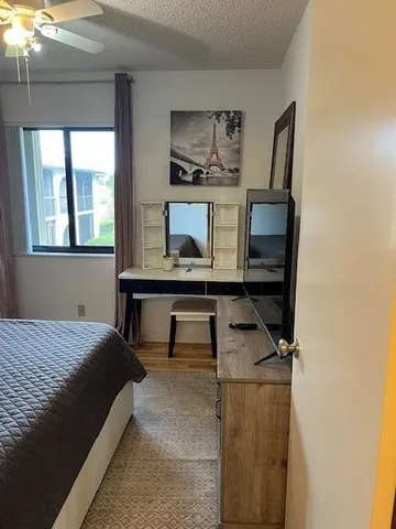 a bedroom with a bed window and table