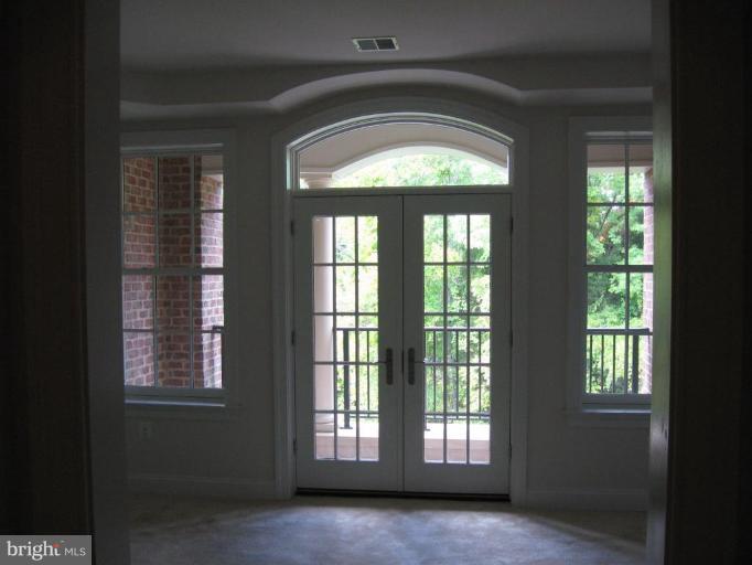 1781 Chain Bridge Road, Unit 301 McLean, VA 22102 - Photo 6 of 10 Living Room with French Door and Eyebrow Transom