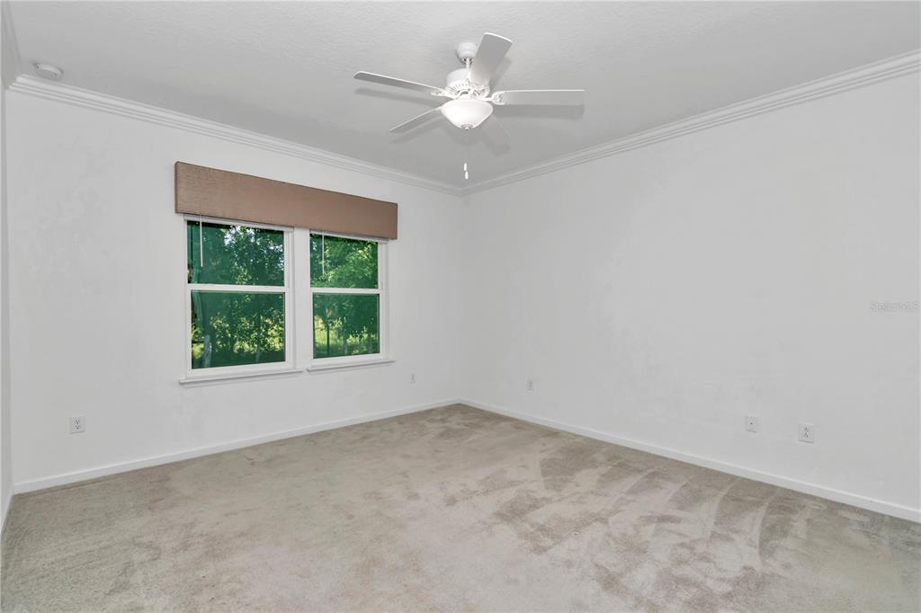 7867 Southwest 74th Loop Ocala, FL 34481 - Photo 21 of 55 an empty room with a window and a ceiling fan