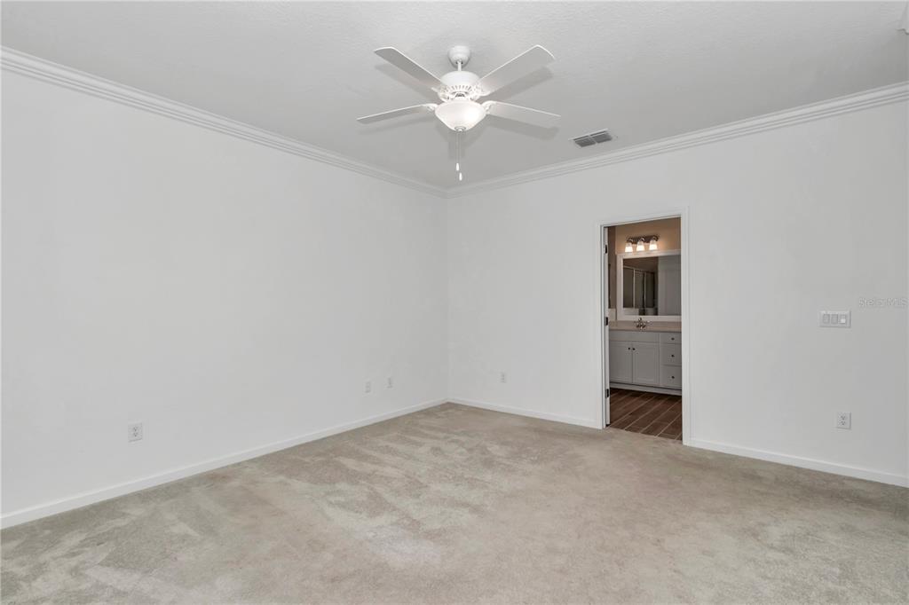 7867 Southwest 74th Loop Ocala, FL 34481 - Photo 22 of 55 an empty room with closet and a ceiling fan