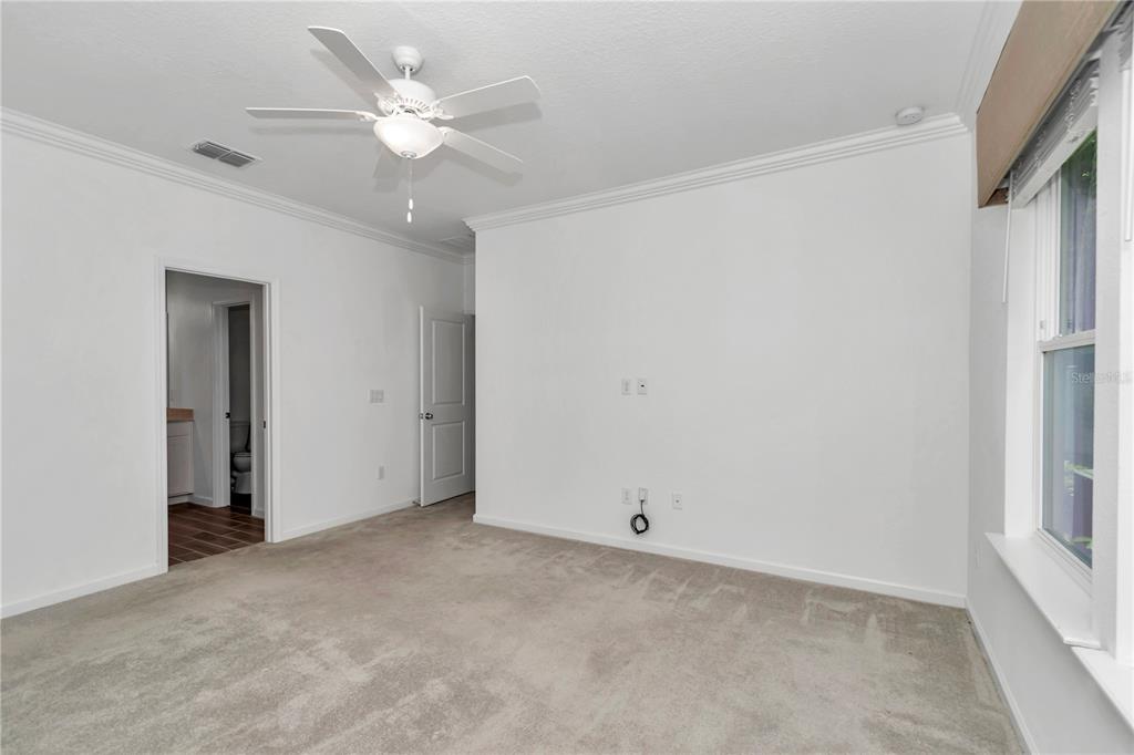 7867 Southwest 74th Loop Ocala, FL 34481 - Photo 23 of 55 an empty room with a ceiling fan and a window
