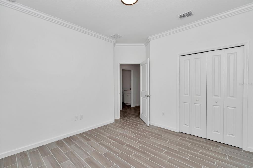 7867 Southwest 74th Loop Ocala, FL 34481 - Photo 29 of 55 a view of an empty room with wooden floor