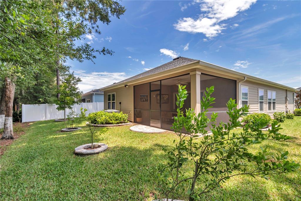 7867 Southwest 74th Loop Ocala, FL 34481 - Photo 41 of 55 a front view of a house with garden