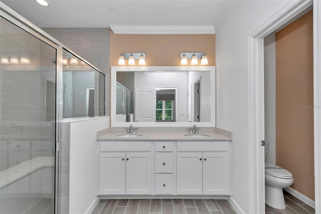 7867 Southwest 74th Loop Ocala, FL 34481 - Photo 46 of 55 a bathroom with a double vanity sink and a toilet