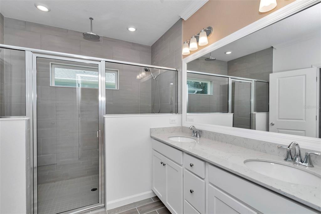 7867 Southwest 74th Loop Ocala, FL 34481 - Photo 5 of 55 a bathroom with a granite countertop sink mirror and double