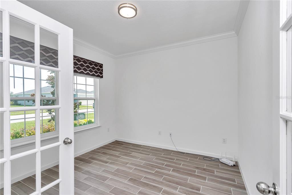 7867 Southwest 74th Loop Ocala, FL 34481 - Photo 9 of 55 a view of a livingroom with wooden floor and a window