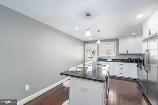 a kitchen with a sink window and refrigerator