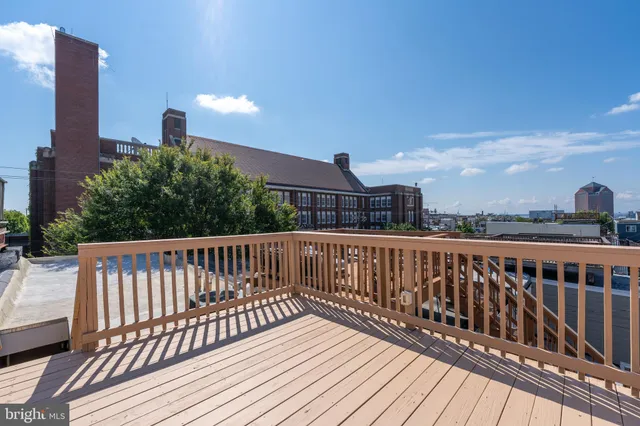 a view of roof deck with two chairs and wooden floor