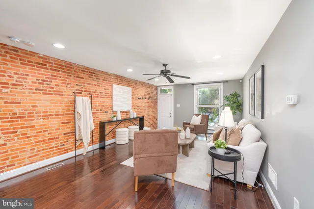 a living room with fireplace furniture and a wooden floor