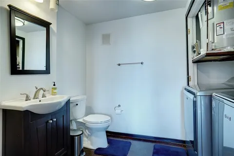 a kitchen with stainless steel appliances granite countertop a stove a refrigerator a kitchen island a dining table and chairs