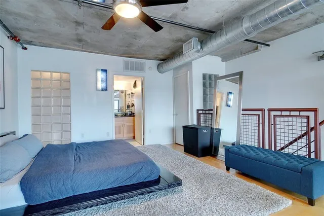 a bed room with a bed and a chair